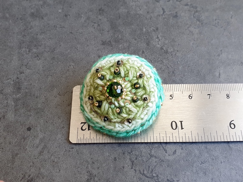 green crocheted brooch