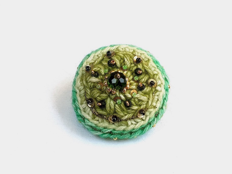 green crocheted brooch